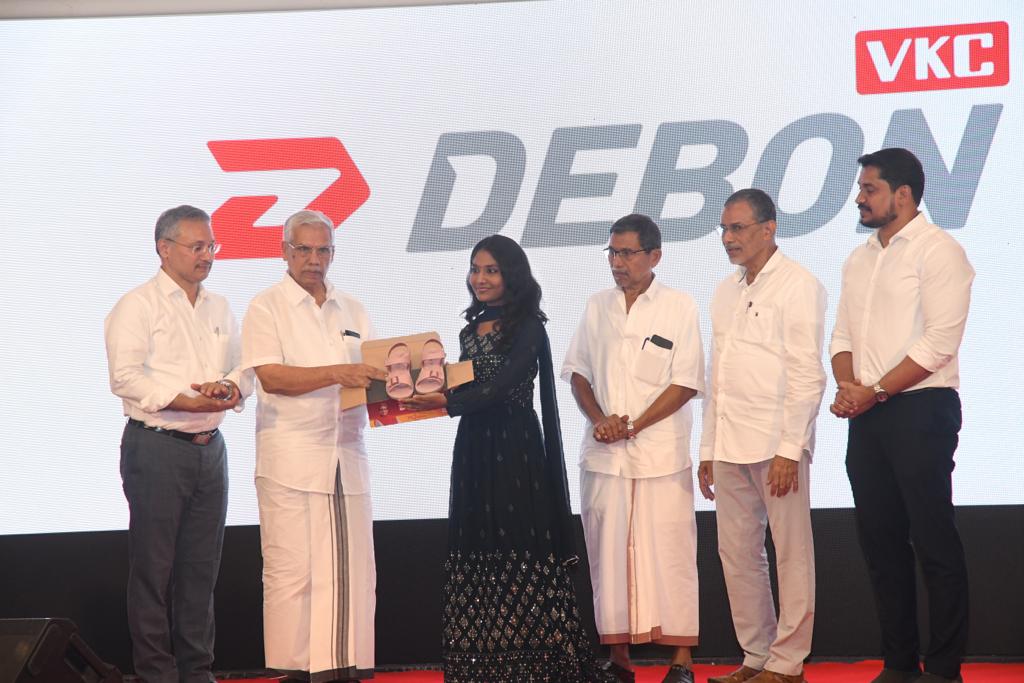 VKC Mammad Koya, Chairman VKC Group launches the brand VKC DEBON by presenting VKC DEBON footwear to popular reality show fame Ms. Aryananda. VKC Group Managing Director VKC Razak, Directors V Rafeeq, Muhammad Kutty, V Muhammad and others are also seen.